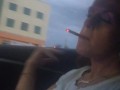 Milf smoking cigarettes while in passenger seat in vehicle