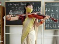 Indian Teacher play Violin Lessons in her class room