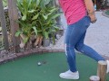 Small petite girl playing golf and not doing good at it