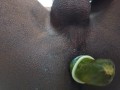 Putting a cucumber in the ass while jerking off with a condom