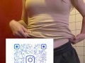 Charming girl takes off her bra from under her T-shirt