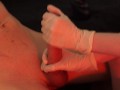 Mercilessly playing with his dick in medical gloves