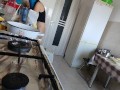 Sexy Latina nude in the kitchen. Sexy naked wife prepares food in the kitchen.