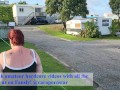 Trashy MILF slut pisses on the grass in front of other campers at the beach