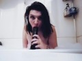 Sucking and gagging on a big dildo in the bathtub