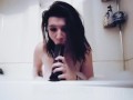 Sucking and gagging on a big dildo in the bathtub