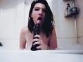 Sucking and gagging on a big dildo in the bathtub