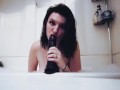 Sucking and gagging on a big dildo in the bathtub