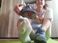 Sweaty feet after workout. Stinky socks and sneakers.Sniffing - OlgaNovem