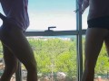 Two sweet lesbians dance naked in front of the window