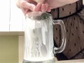 Sexy milf in lingerie squirting breastmilk into cup