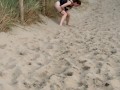 Nervous woman caught peeing in public at the beach