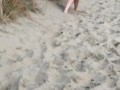 Nervous woman caught peeing in public at the beach