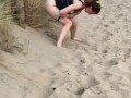 Nervous woman caught peeing in public at the beach
