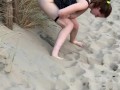 Nervous woman caught peeing in public at the beach