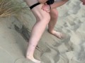 Nervous woman caught peeing in public at the beach
