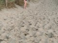 Nervous woman caught peeing in public at the beach
