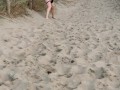 Nervous woman caught peeing in public at the beach