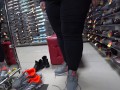 Foot fetish in a public shoe store. Fat legs try on sneakers.