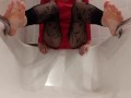 Wetting fishnet leggings feet in a bathtub