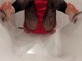 Wetting fishnet leggings feet in a bathtub