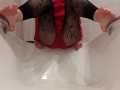 Wetting fishnet leggings feet in a bathtub