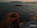 Skinny guy masturbates on a cliff during a sunset in Ibiza