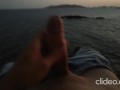 Skinny guy masturbates on a cliff during a sunset in Ibiza
