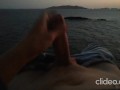 Skinny guy masturbates on a cliff during a sunset in Ibiza