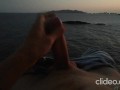 Skinny guy masturbates on a cliff during a sunset in Ibiza