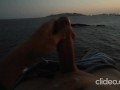 Skinny guy masturbates on a cliff during a sunset in Ibiza