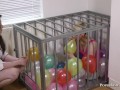 Caged Slave Girl Blows Up Balloons