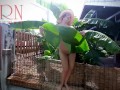 Rural striptease. Country girl dancing in the yard of her house Rustic striptease with banana leaf