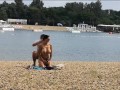 Milf Lilly naked on public beach got oil massage from stranger