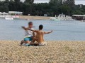 Milf Lilly naked on public beach got oil massage from stranger