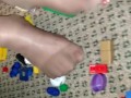 Sexy nylon feet walking on legos