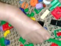 Sexy nylon feet walking on legos