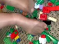 Sexy nylon feet walking on legos