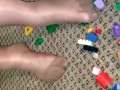 Sexy nylon feet walking on legos