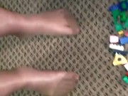 Sexy nylon feet walking on legos