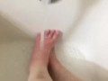 Girl washing sore feet and ankles after working long shift