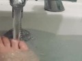 My feet in the bath playing with my rubber duck 