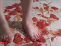 Several tomatoes are crushed under my wonderful bare feet