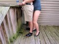 Holding my boyfriend's dick while he pisses off the deck | outside piss | high heels | sexy legs