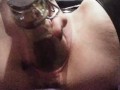 Slut fucks bottle and squirts