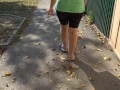 BBW in flip flops walks along the sidewalk while a voyeur peeps on her feet Public foot fetish