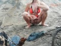 Public peeing teen girl on the beach