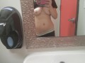 Playing with my big tits at work in the loo