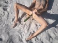 Amateur nudist teen fucks her tight pussy with a huge cucumber on a public beach. Ends with a pee.