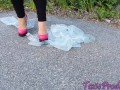 Pink high heels pop bags outdoors